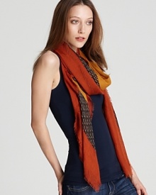 A large woven square scarf with a geometric print and contrast border, an edgy accent for your favorite ensemble. A large woven square scarf with a geometric print and contrast border, an edgy accent for your favorite ensemble.