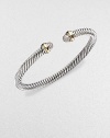 A signature Yurman cable of sterling silver, richly enhanced by bands of 18k yellow gold, encircling pavé diamond domed end caps. Diamonds, 0.30 tcw Sterling silver and 18k yellow gold Cable, 5mm Diameter, about 2½ Made in USA