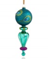 In a delicate finial shape crafted of glass, this lovely ornament swirls and shines upon your tree with a peacock feather motif. Purple glitter at the bottom gives it an extra allure.