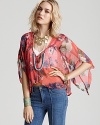 With a nod to the East, this floral Free People top boasts chic kimono sleeves for a unique feature, plus a front placket with red buttons that blend into the vibrant print. Lightly crinkled, the sheer fabrication is spring-ready and perfect layered over a seamless tank.