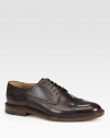 Leather lace-up derby with cap-toe and brogue detailing.Leather soleMade in Italy