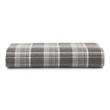 Inspired by the refined polish of menswear, this relaxed collection pairs solid brushed cotton and twill with faux suede trim and plaid. Sheets and pillowcases are in a soft cotton bold plaid in a grey and white palette.