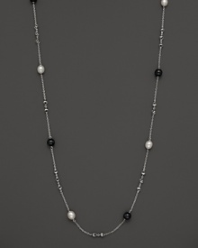 This sterling silver necklace, gleaming with blue tigers eye and freshwater pearls, makes an elegant statement. By Di MODOLO.