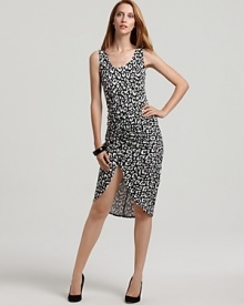 A high-contrast print of leopard spots in black and white, alluring ruching, and a dramatic side slit add up to a powerful presence in this Karen Kane dress.