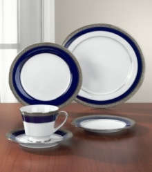 Formal white fine china displays a dramatic combination of scrolling leaves on shimmering platinum and an inner band of intense cobalt blue. Dishwasher safe. Formal white fine china displays a dramatic combination of scrolling leaves on shimmering platinum and an inner band of intense cobalt blue. Dishwasher safe.