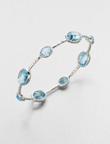 From the Rock Candy Collection. A graceful bangle of sculptural sterling silver is dotted with richly faceted ovals of dinsinctively hued blue topaz.Blue topazSterling silverDiameter, about 2.6Imported From the Rock Candy Collection. A graceful bangle of sculptural sterling silver is dotted with richly faceted ovals of dinsinctively hued blue topaz.Blue topazSterling silverDiameter, about 2.6Imported