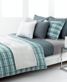 The Odum duvet cover set from Lacoste features an effortless plaid pattern in a mixture of moss green and smoky blue over ultra-comfortable cotton. Subtle lines of light rust run through the casual look, offering a coordinate with textured Lacoste bedding accents. The Odum duvet cover set from Lacoste features an effortless plaid pattern in a mixture of moss green and smoky blue over ultra-comfortable cotton. Subtle lines of light rust run through the casual look, offering a coordinate with textured Lacoste bedding accents.