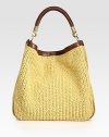 An incredibly roomy bag crafted from woven raffia and sumptuous leather trim.Top handle, 9½ dropTop snap closureOne inside zip pocketTwo inside open pocketsSuede lining14W X 14½H X 6DImported