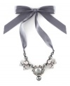 This satin ribbon necklace is as pretty as a gift-wrapped package. This elegant piece from the Jessica Simpson collection features gray glass pearls, beads, and crystals. Set in silvertone mixed metal. Approximate length: 17 inches. Approximate drop: 2 inches.