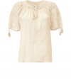 Raise the bar on contemporary classics with Closeds boho-chic beige tunic top - In a soft, semi-sheer summer viscose - On trend, allover embroidery and decorative tie embellishments - Short puffed sleeves and gathered keyhole tie neck - Relaxed, billowy silhouette - Casually cool, perfect for pairing with shorts, skinny denim and slim, cropped trousers