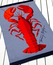 Tommy Hilfiger brings a lively sea creature to this beach towel, featuring a large red lobster on a chic ground of navy and white stripes. Finished with the Tommy Hilfiger signature.