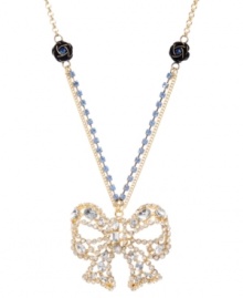 Top off your look to complete the package. Betsey Johnson's ultra-feminine pendant features a crystal-encrusted bow strung from a blue crystal cup chain with flower charm accents. Set in gold-plated mixed metal. Approximate length: 16 inches + 3-inch extender. Approximate drop: 2 inches. Top off your look to complete the package. Betsey Johnson's ultra-feminine pendant features a crystal-encrusted bow strung from a blue crystal cup chain with flower charm accents. Set in gold-plated mixed metal. Approximate length: 16 inches + 3-inch extender. Approximate drop: 2 inches.