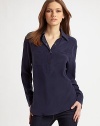 Classic henley style reimagined in fine silk with an easy, oversized shape and convertible sleeves.Point collar Partial front snap placket Long sleeves with snap cuffs convert to ¾ sleeves with button tabs Front patch pockets Shirttail hem Center back box pleat Back seaming with cutout detail About 27 from shoulder to hem Silk; dry clean Imported