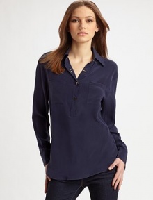 Classic henley style reimagined in fine silk with an easy, oversized shape and convertible sleeves.Point collar Partial front snap placket Long sleeves with snap cuffs convert to ¾ sleeves with button tabs Front patch pockets Shirttail hem Center back box pleat Back seaming with cutout detail About 27 from shoulder to hem Silk; dry clean Imported