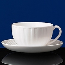 Simple shapes of crisp white are accented with precisely etched lines. Contrasting black matte jasper accessories with glazed interiors are also available. Bone china. Simple shapes of crisp white are accented with precisely etched lines. Contrasting black matte jasper accessories with glazed interiors are also available. Bone china.