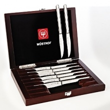 These Wüsthof high-carbon, precision forged, 18/10 stainless steel steak knives feature a serrated cutting edge and polished handles. Includes wood presentation box with rosewood stain. These Wüsthof high-carbon, precision forged, 18/10 stainless steel steak knives feature a serrated cutting edge and polished handles. Includes wood presentation box with rosewood stain.