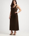 Featuring a classic dropped waist, this jersey dress features an alluring neckline and seductive side slits to draw attention to your legs. ScoopneckSleevelessSelf-tie belt at dropped waistSide slit on each sidePull-on styleAbout 38 from natural waist94% polyester/6% spandexMachine washImported