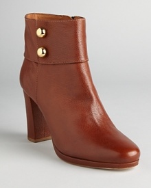 These commanding booties spell sophistication; metallic, military inspired buttons add some dash; from kate spade new york. These commanding booties spell sophistication; metallic, military inspired buttons add some dash; from kate spade new york.