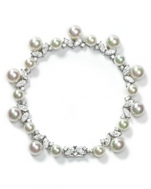 Pearls dangle from a glittering, ruffled bracelet by Majorica creating an ultra-feminine accent.