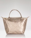 Take a shine to Longchamp's punched-up play on practical, boasting metallic nylon and leather trims. In understated style, this bag hints at Left Bank chic.