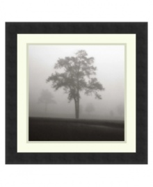 Almost eerie in black and white, this photo print sets a quiet, contemplative mood. A lone tree comes into focus despite dense fog while, in the distance, others are barely visible. Framed in smooth, clean black.