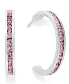 Traditions gives a sparkling boost to a simple pair of hoop earrings. A channel-set row of round-cut pink crystal with Swarovski elements shines within a sterling silver setting. Earrings feature a post and stud backing. Approximate diameter: 3/4 inch. Traditions gives a sparkling boost to a simple pair of hoop earrings. A channel-set row of round-cut pink crystal with Swarovski elements shines within a sterling silver setting. Earrings feature a post and stud backing. Approximate diameter: 3/4 inch.