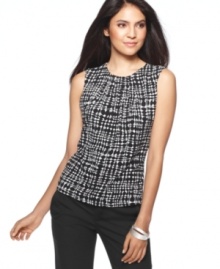 A bold print makes this sleeveless blouse the perfect piece to pair with a blazer for work. Mix and match with ease--it coordinates beautifully with other pieces from Calvin Klein's collection of suiting separates. A bold print makes this sleeveless blouse the perfect piece to pair with a blazer for work. Mix and match with ease--it coordinates beautifully with other pieces from Calvin Klein's collection of suiting separates.
