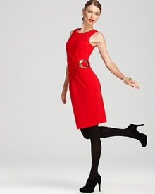 Starburst pleating and a gleaming metal ring lend modern flair to this timeless Calvin Klein shift dress.