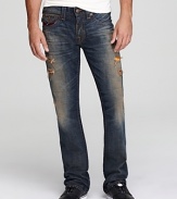 A multicolor patch adorns the back pocket of these heavily distressed and destroyed jeans, a powerfully cool design from none other than True Religion.