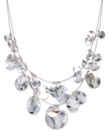 Put your chips on the table with this illusion necklace from Sequin. Two rows string shimmering pendants in a rounded design. Crafted in silver tone mixed metal. Approximate length: 17 inches + 3-inch extender.