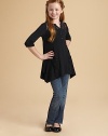 An easy knit tunic with gracefully draped longer sides has a yoke and pockets of pretty lace.Banded round notched necklineHalf button placketLace front yokeThree-quarter sleevesLace patch pocketsDraped, longer side split hems95% viscose/5% spandexHand washImported Please note: Number of buttons may vary depending on size ordered. 