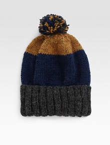 Colorblock detail overtakes this slouchy cold weather essential, cable knitted from baby alpaca topped with a mixed pom pom detail.AlpacaSpot cleanMade in USA Colorblock detail overtakes this slouchy cold weather essential, cable knitted from baby alpaca topped with a mixed pom pom detail.AlpacaSpot cleanMade in USA