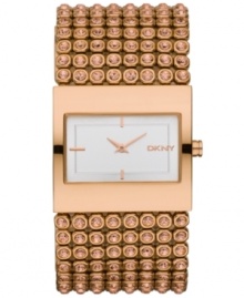 A shining example of detailed elegance from DKNY. Watch crafted of rose-gold ion-plated stainless steel bracelet embellished with rose-gold tone crystal accents and rectangular rose-gold ion-plated stainless steel case. White dial features rose-gold tone two hands, stick indices at six, nine and twelve o'clock and logo at three o'clock. Quartz movement. Water resistant to 30 meters. Two-year warranty.