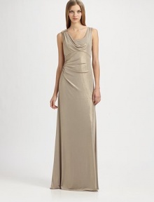 Fluid metallic jersey, in an artfully draped, floor-length style accented with a beaded shoulder detail.ScoopneckShoulder drape with beaded detailSleevelessEmpire seamSide gathers at waistBack cutout with gathered drapeAbout 42 from natural waist95% polyester/5% spandexDry cleanMade in USA of imported fabricModel shown is 5'10 (177cm) wearing US size 4. 