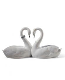 Exquisitely crafted of porcelain, the Endless Love figurine by Lladro presents a pair of snowy swans united in love. Designed as a wedding cake topper, or a bridal or anniversary gift, this heirloom quality collectible will be cherished for generations to come. 5.25 x 10.5. Exquisitely crafted of porcelain, the Endless Love figurine by Lladro presents a pair of snowy swans united in love. Designed as a wedding cake topper, or a bridal or anniversary gift, this heirloom quality collectible will be cherished for generations to come. 5.25 x 10.5.