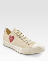 An eye-catching heart peers out from the side of these canvas classics, finished with a contrast stripe at the heel. Rubber toe Lace-up front Painted heart on side Back stripe Padded insole Rubber sole ImportedOUR FIT MODEL RECOMMENDS ordering true whole size; ½ sizes should order the next whole size down. 