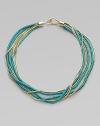 A stunning contrast of bold turquoise beaded strands and radiant, goldtone snake chains in a fluid, multi-row design. TurquoiseGoldtone brassLength, about 17Hook closureImported 