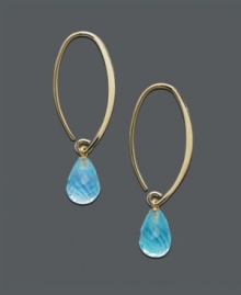 A tropical delight - ocean blue drops in gold transform any look to the exotic. 14k gold oval hoop earrings feature a dazzling, faceted blue topaz teardrop (8-3/4 ct. t.w.). Approximate diameter: 1-1/2 inches.