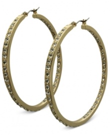 Fashion that covers all bases. These golden hoop earrings from GUESS sparkle both inside and out with glass accents. Crafted in gold tone mixed metal. Approximate drop: 2 inches.