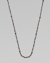 A simply chic design with 14k gold beads on oxidized sterling silver coil links. 14k gold beadsOxidized sterling silverLength, about 28Spring ring closureMade in USA 