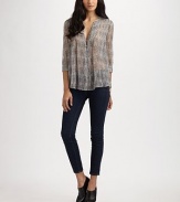 Airy, semi-sheer v-neck in pure silk. V-neck Button front Three-quarter sleeves Silk Dry clean Imported