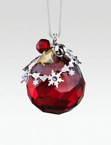 A cheery, faceted crystal sphere in holiday red, sweetly adorned with silvertone shapes and a tiny jingle bell.CrystalSilvertoneAbout 1.5H X 1.25WMade in Austria A cheery, faceted crystal sphere in holiday red, sweetly adorned with silvertone shapes and a tiny jingle bell.CrystalSilvertoneAbout 1.5H X 1.25WMade in Austria