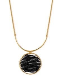 Center of attention. Kenneth Cole New York takes a circular path to style with this necklace. Crafted from gold-tone mixed metal, the pendant stands out with black cherry beads in the middle. Approximate length: 16 inches + 3-inch extender. Approximate drop: 2-1/4 inches.