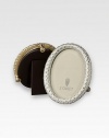 A keepsake accent for life's favorite moments and people, upholstered in smooth leather with gold- or platinum-plating and glimmering Swarovski crystals. Accommodates a 2 X 3 round photograph Hand wipe Imported