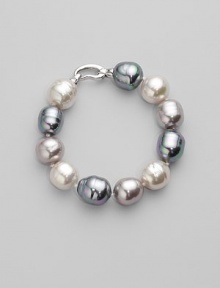 A stunning bracelet of baroque pearls in a palette of whisper soft pastels. 14mm white, grey and nuage man-made organic pearls Length, about 8 Rhodium-plated sterling silver spring clip clasp Made in Spain