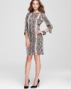 This Jones New York Collection dress takes your executive style on an exotic spin as sleek snakeskin print enlivens a classic sheath silhouette, finished with zip shoulder accents for untamed edge.