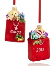 Embrace the holiday frenzy with the Macy's shopping bag ornament. Stuffed with dazzling gifts and dated for the season, it's a perfect stocking stuffer for the shopaholics on your list. Shown front and back.