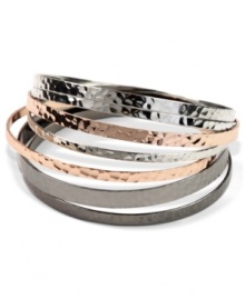 Non-stop elegance. With silver tone, rose-gold tone and hematite tone mixed metals, Nine West's seven piece bangle bracelet set allows you to change your look on the fly. Approximate diameter: 2-1/2 inches.