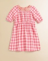 Rendered in pure cotton, this soft and sweet gingham print frock is perfect for school, play or a party.Ruched crewneck with bowShort puffed sleeves with elastic cuffsElastic waistShirttail hemCottonMachine washImported