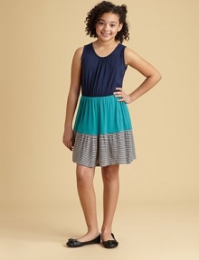 A trendy colorblock detail adds pizazz to this pretty, flowy frock.ScoopneckSleevelessPullover styleElastic waistFull skirtStriped ruffles at hem95% rayon/5% spandexHand washMade in USA A trendy colorblock detail adds pizazz to this pretty, flowy frock.ScoopneckSleevelessPullover styleElastic waistFull skirtStriped ruffles at hem95% rayon/5% spandexHand washMade in USA